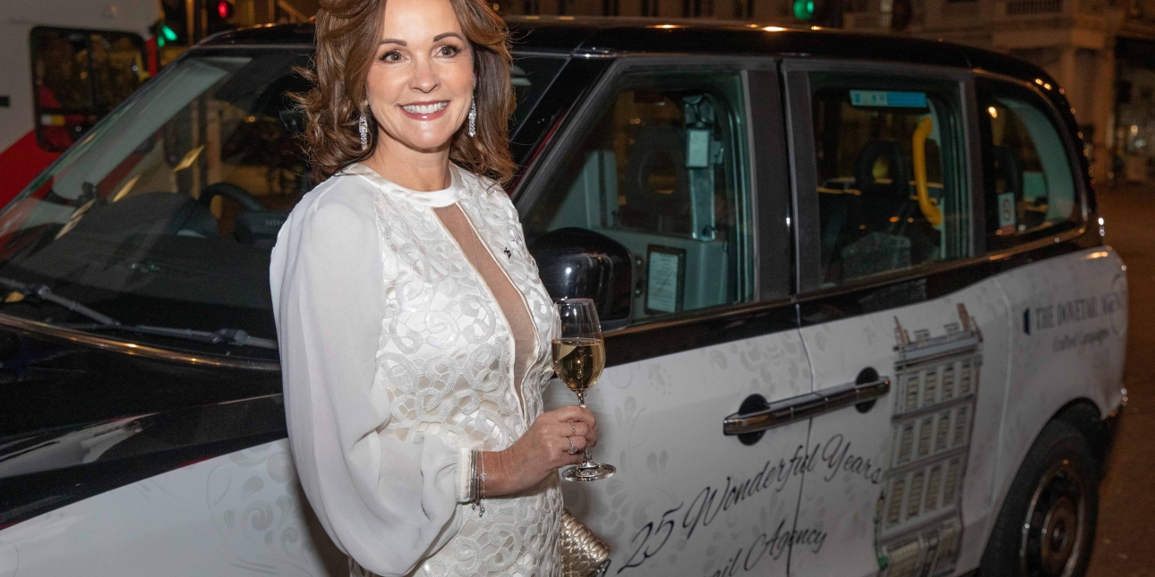 Jayne Alexander next to a London taxi